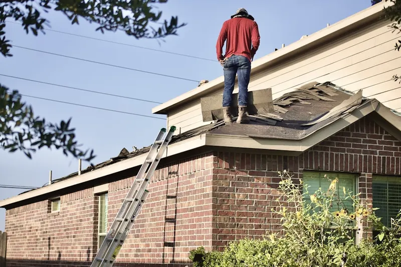 Professional roofer working on a residential roof in Spout Spring Crossroads